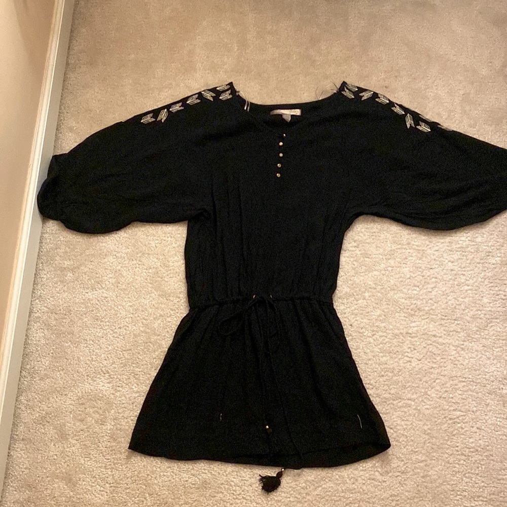 Mini black dress with white and blue designs on shoulders